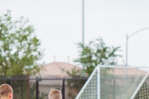 2 men playing soccer during daytime