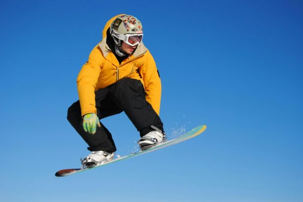 man in yellow jacket and blue pants riding on white snowboard