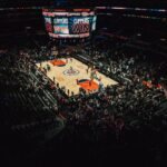 people watching football game during nighttime