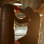 man kicking the heavy bag