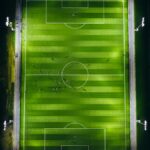 bird's-eye view photography of green soccer field with lights